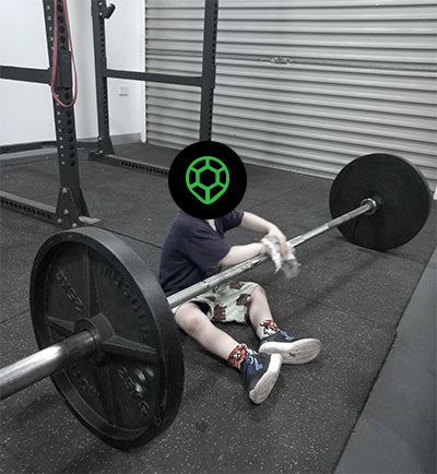 Kid enjoying cleaning barbell in gym
