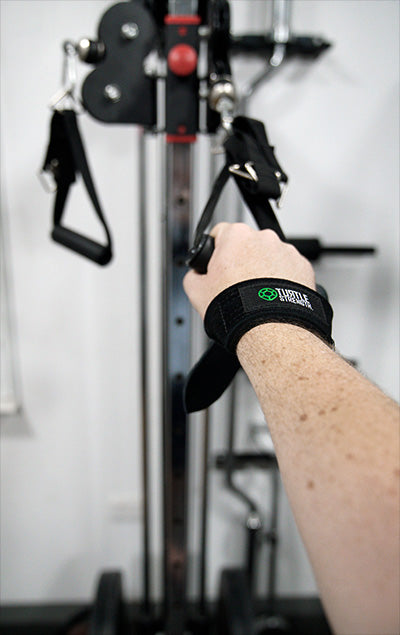 Person using cable machine with lifting straps
