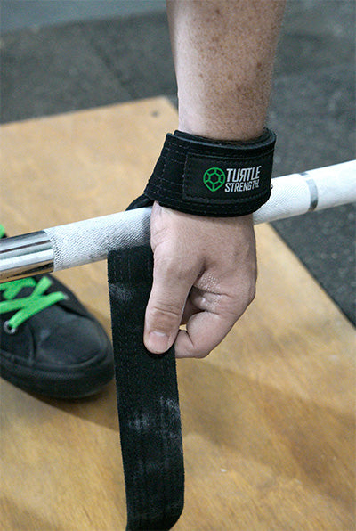 lifting straps about to wrap around bar