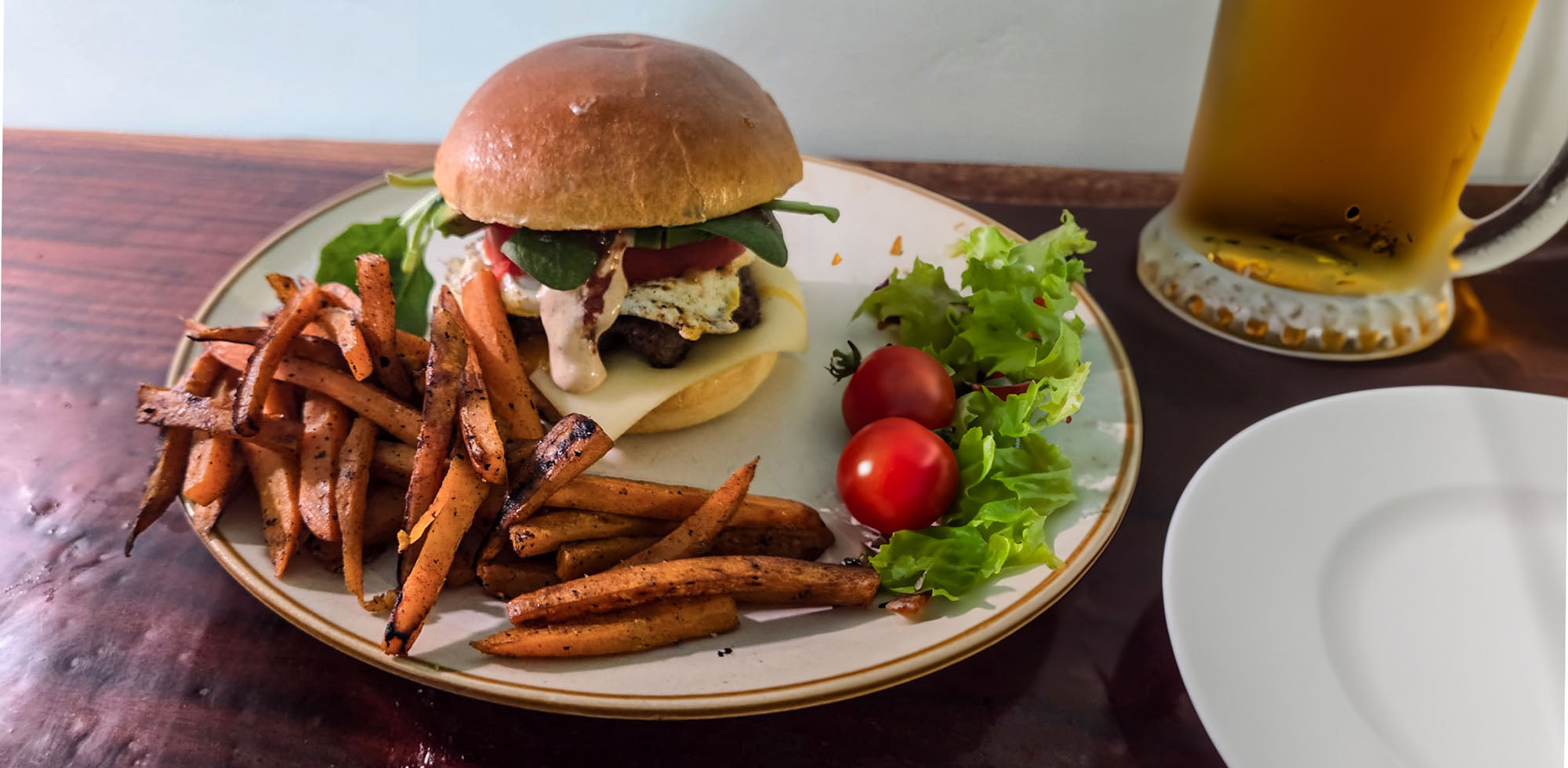 high protein smashed burger recipe on plate with sweet potato chips