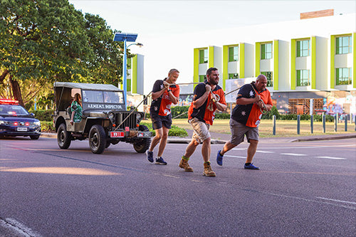 Leather lifting straps lying on a rubber barbell plates